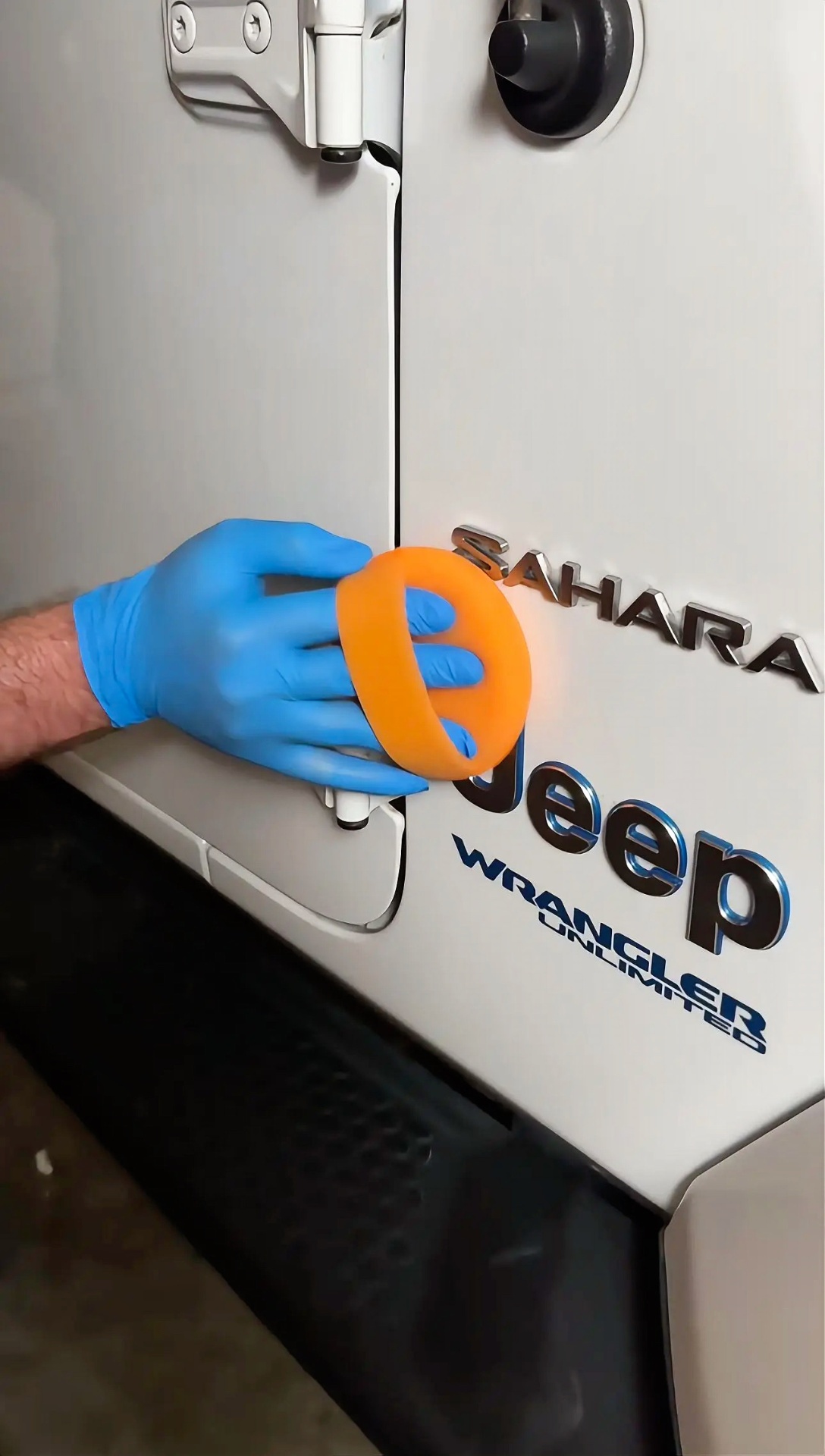 Ceramic coating application with orange applicator on Jeep Wrangler